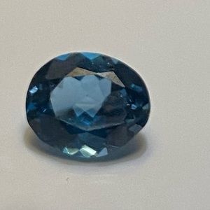 Approximately 8 x 7 mm oval blue topaz